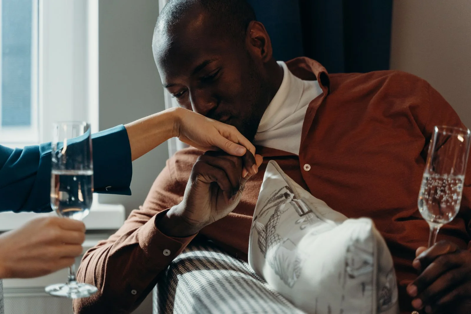 An elegant couple sharing a warm, candlelit moment — meet elite singles on EliteSweet